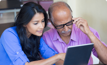 Woman and man starting at laptop