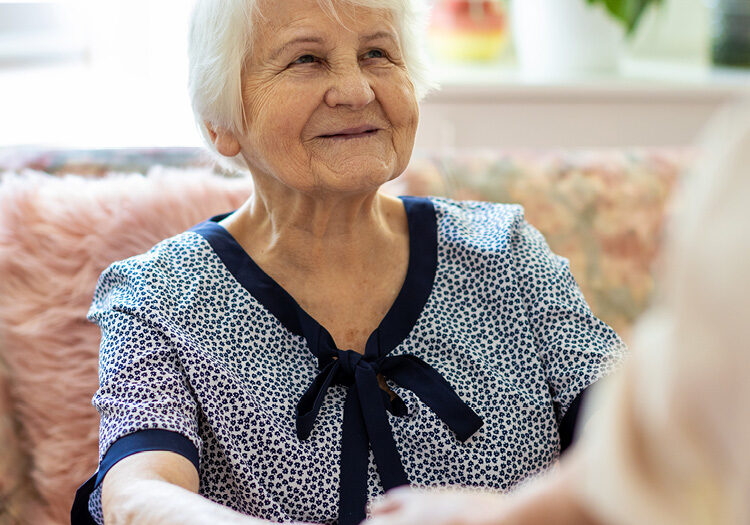 older woman holding hands