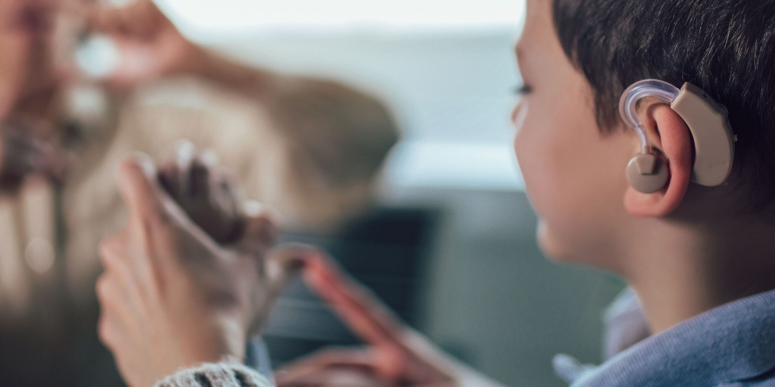 little boy with assistive tech