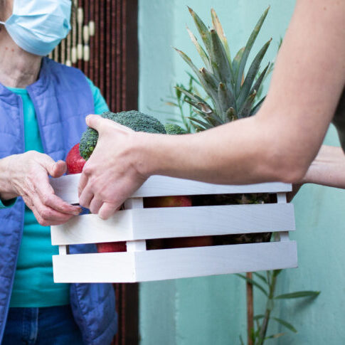 Lady wearing mask delivering food